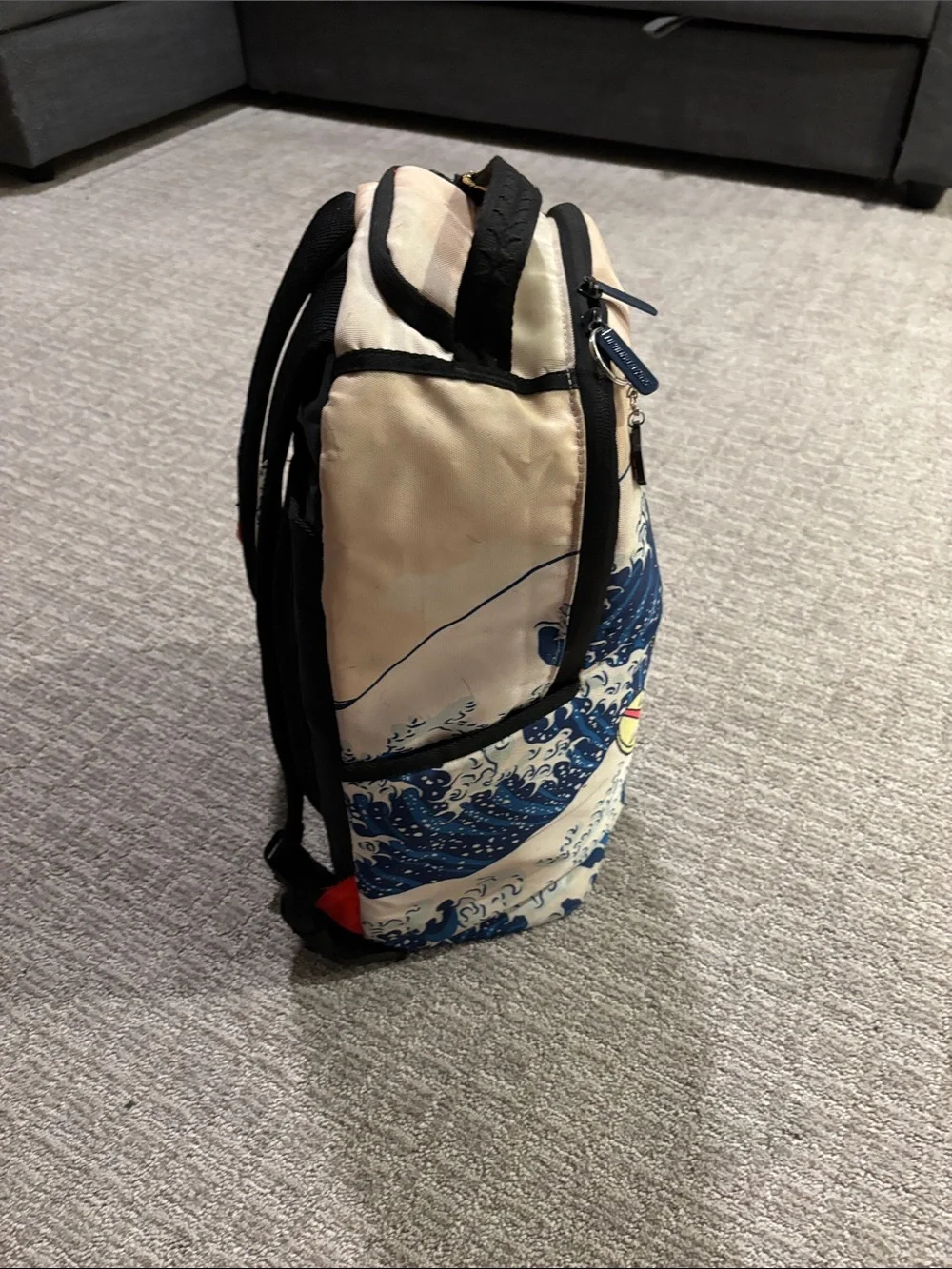 Sprayground Beige Backpack with Blue Wave and Surfing Cartoon